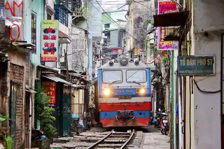 In Hanoi, a train shaves the walls of narrow streets