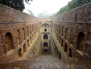 A photographer is closely interested in forgotten wells in India