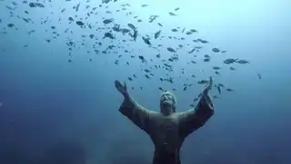 The statue under the water of the Christ of the Abyss of San Fruttuoso in Italy