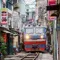 In Hanoi, a train shaves the walls of narrow streets